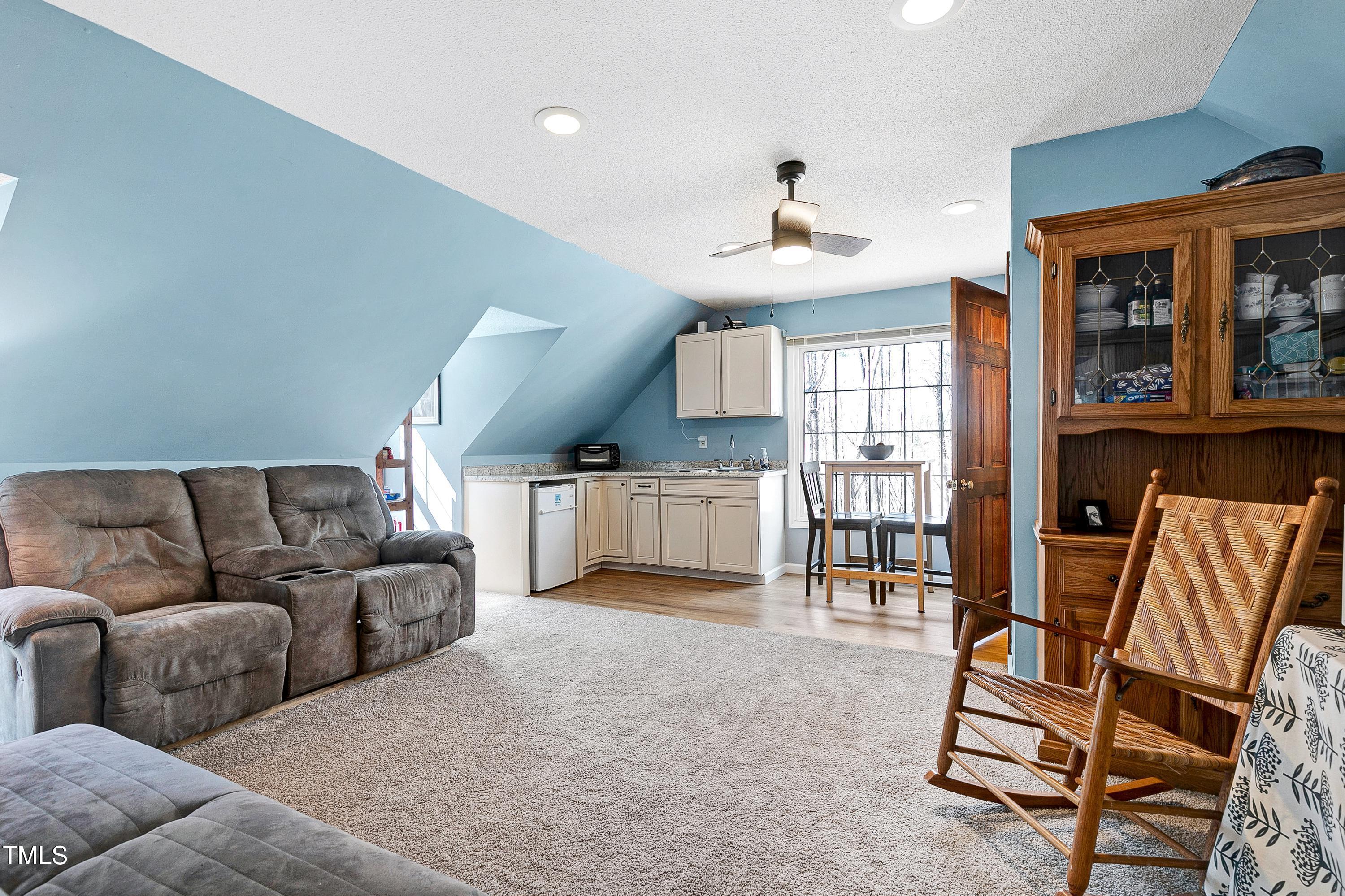10021 Sycamore Road Raleigh, NC 27613 - Photo 28 of 40 a living room with furniture and a large window