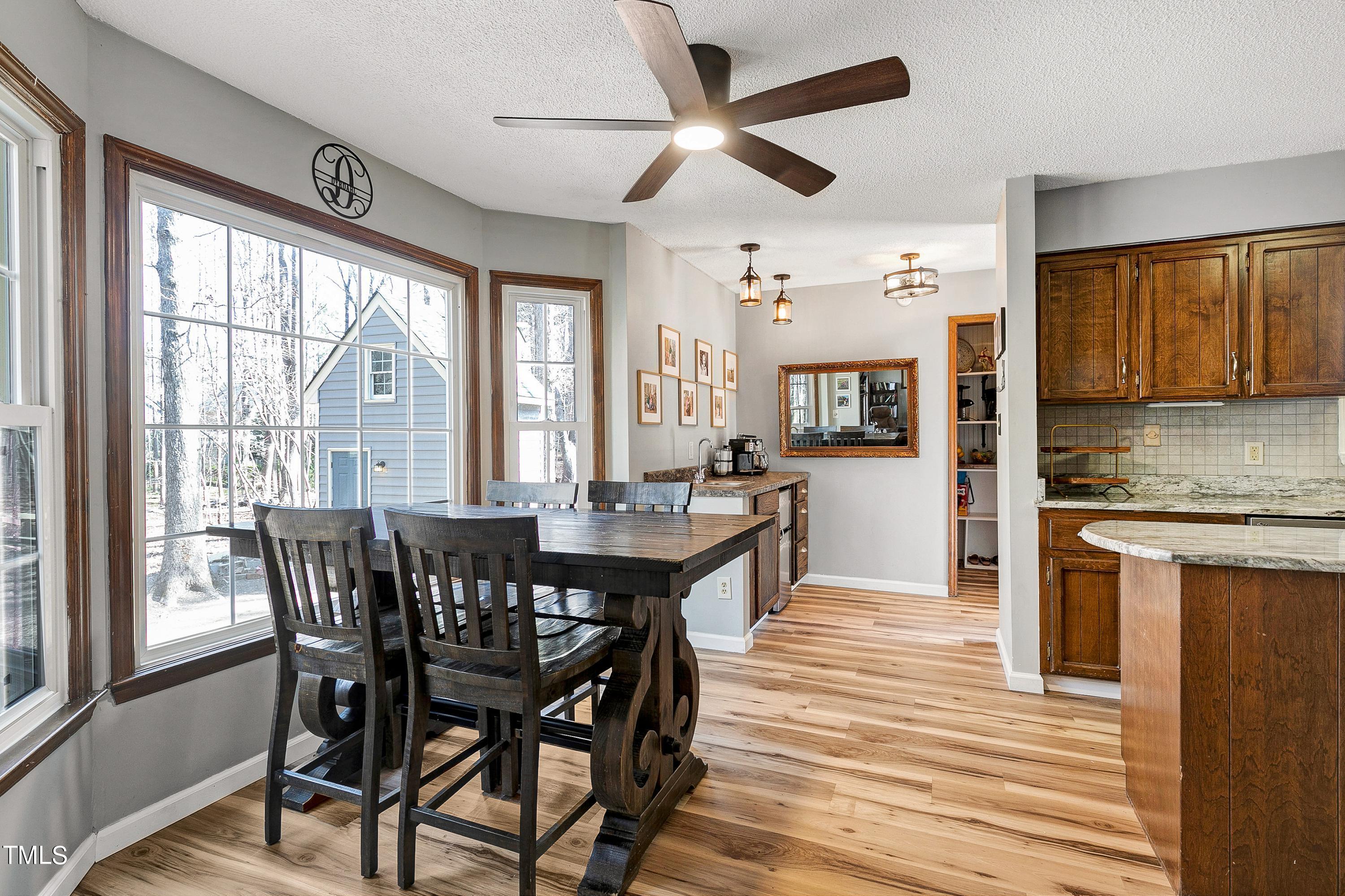 10021 Sycamore Road Raleigh, NC 27613 - Photo 10 of 40 a view of a dining room with furniture window and wooden floor