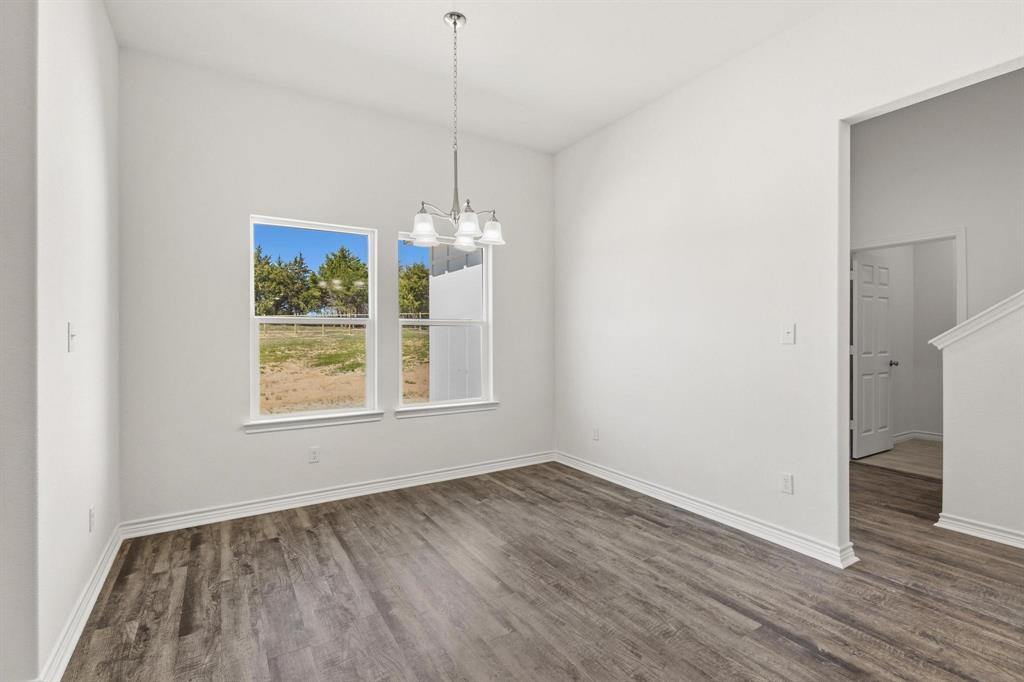 850 County Road Honey Grove, TX 75446 - Photo 12 of 40 a view of an empty room with wooden floor and a window