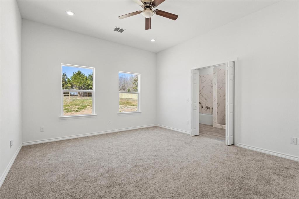 850 County Road Honey Grove, TX 75446 - Photo 17 of 40 an empty room with windows and ceiling fan