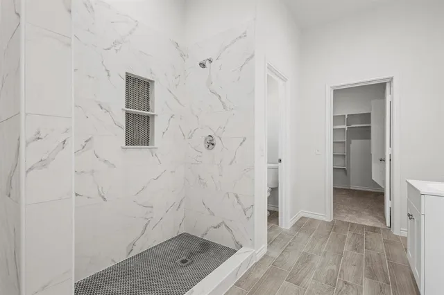 a bathroom with a shower and a sink