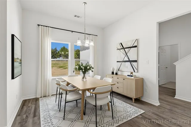 a view of a dining room with furniture window and wooden floor