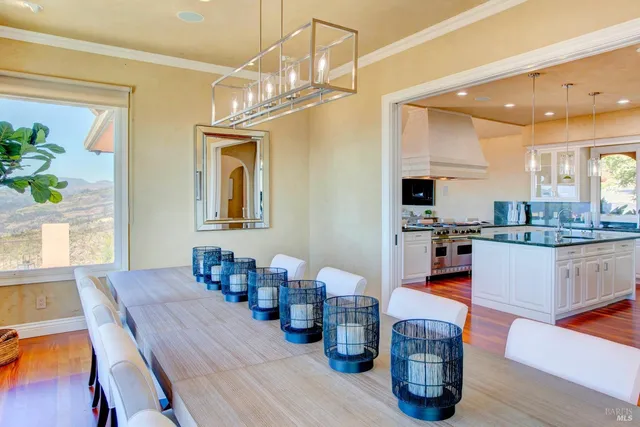 a dining room with wooden floor and furniture