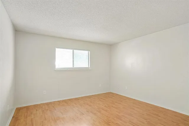 a view of a big room with wooden floor and fan