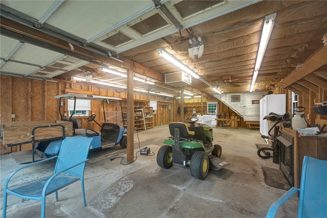 1016 Campbell Road Belton, SC 29627 - Photo 34 of 50 A spacious, well-lit garage offers ample storage for vehicles and equipment, with an accessible second story.