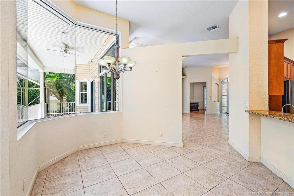 105 Henry Sewall Way Stuart, FL 34996 - Photo 11 of 33 a view of a hallway with a chandelier