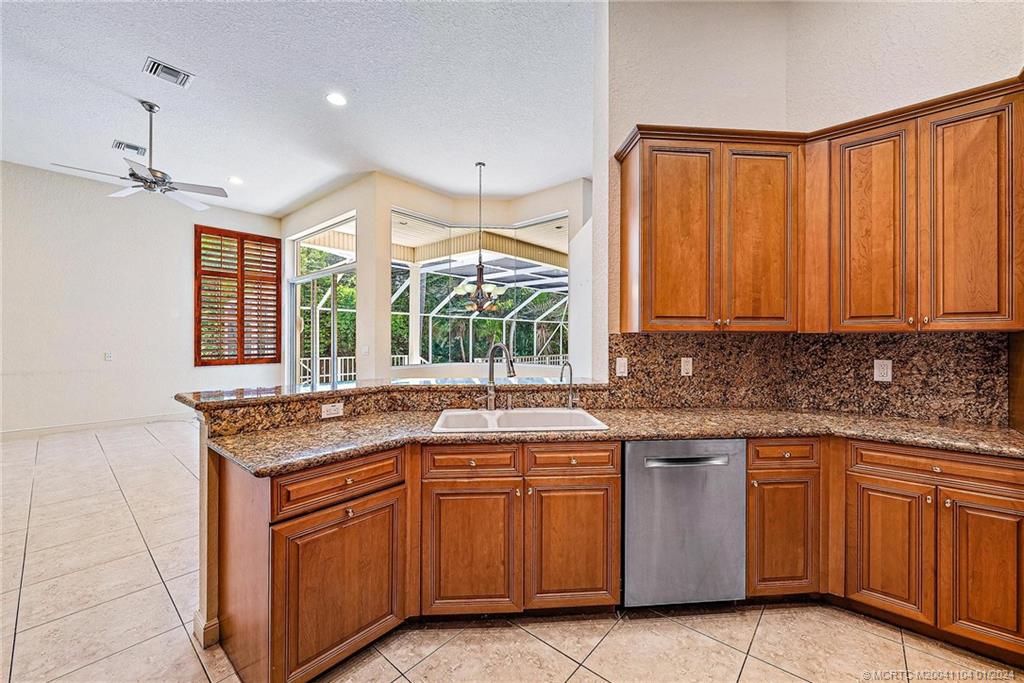 105 Henry Sewall Way Stuart, FL 34996 - Photo 15 of 33 a kitchen with a sink stove and cabinets
