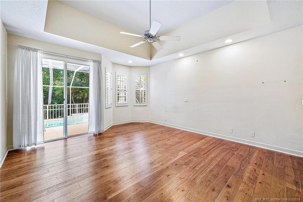 105 Henry Sewall Way Stuart, FL 34996 - Photo 25 of 33 an empty room with wooden floor and windows