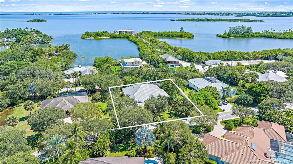 105 Henry Sewall Way Stuart, FL 34996 - Photo 3 of 33 an aerial view of a house with a yard and lake view