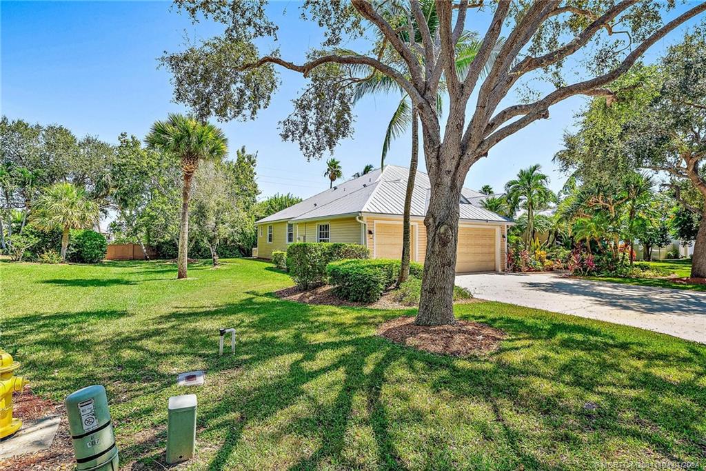 105 Henry Sewall Way Stuart, FL 34996 - Photo 5 of 33 a front view of a house with yard and green space