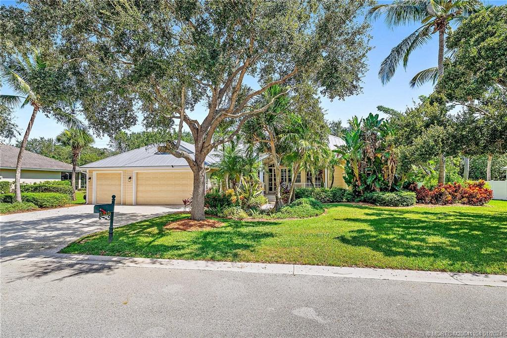 105 Henry Sewall Way Stuart, FL 34996 - Photo 6 of 33 a front view of a house with a yard and a garage