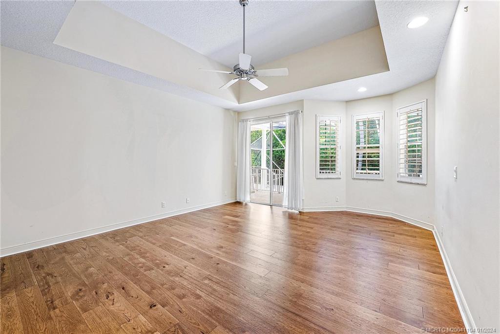 105 Henry Sewall Way Stuart, FL 34996 - Photo 10 of 33 a view of an empty room with wooden floor and a window