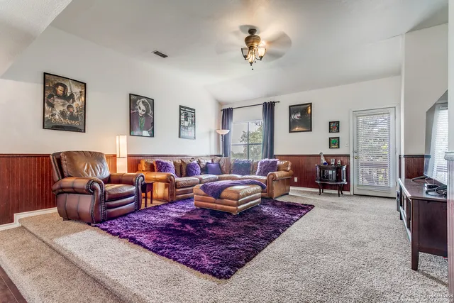 a living room with furniture rug and window