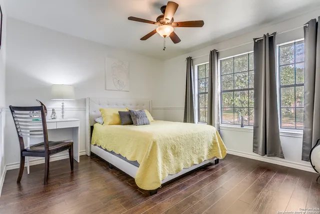 a large bed sitting in a bedroom next to a window