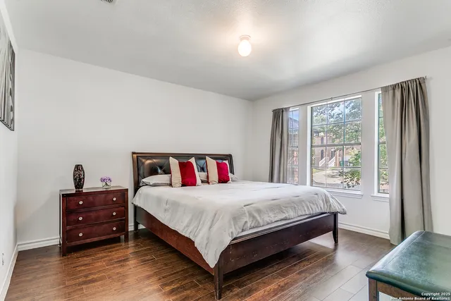 a bedroom with a bed and a large window