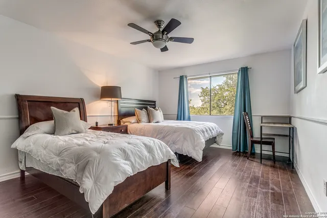 a bedroom with two beds and a table