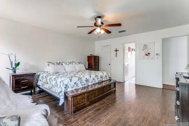 a bedroom with a bed and wooden floor
