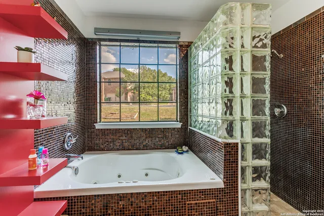 a bathroom with a bathtub and shower