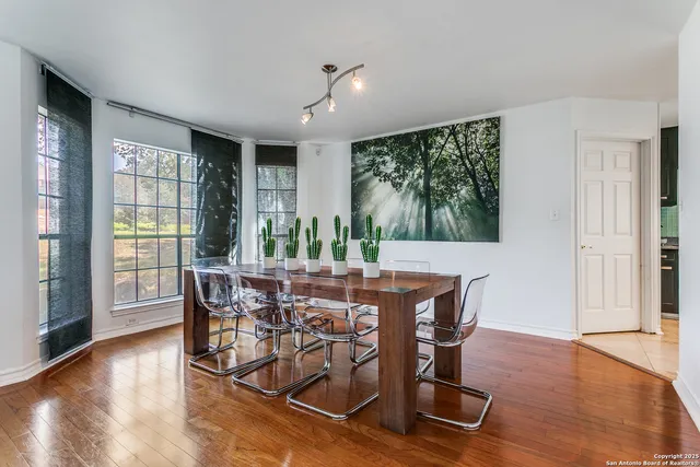 a view of a dining room with furniture window and wooden floor