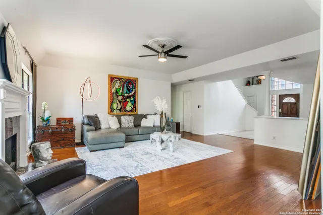 a living room with furniture and a view of kitchen
