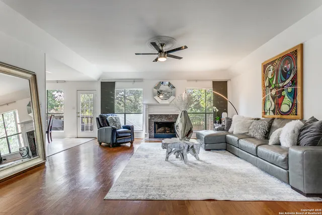 a living room with furniture a fireplace and a table