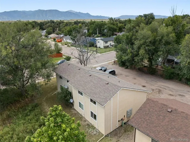 an aerial view of a house with a yard