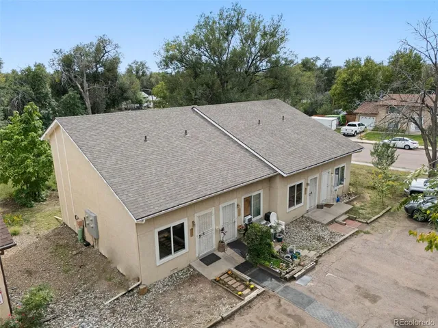 a aerial view of a house next to a yard
