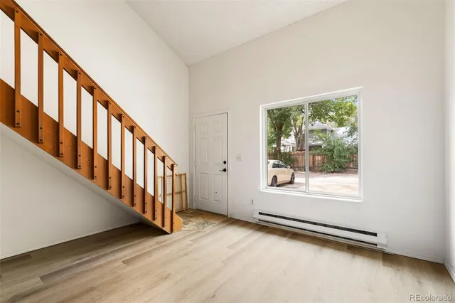 a view of an entryway with wooden floor leading from a balcony