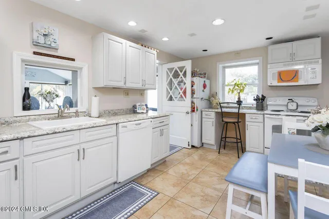 a kitchen with cabinets and window