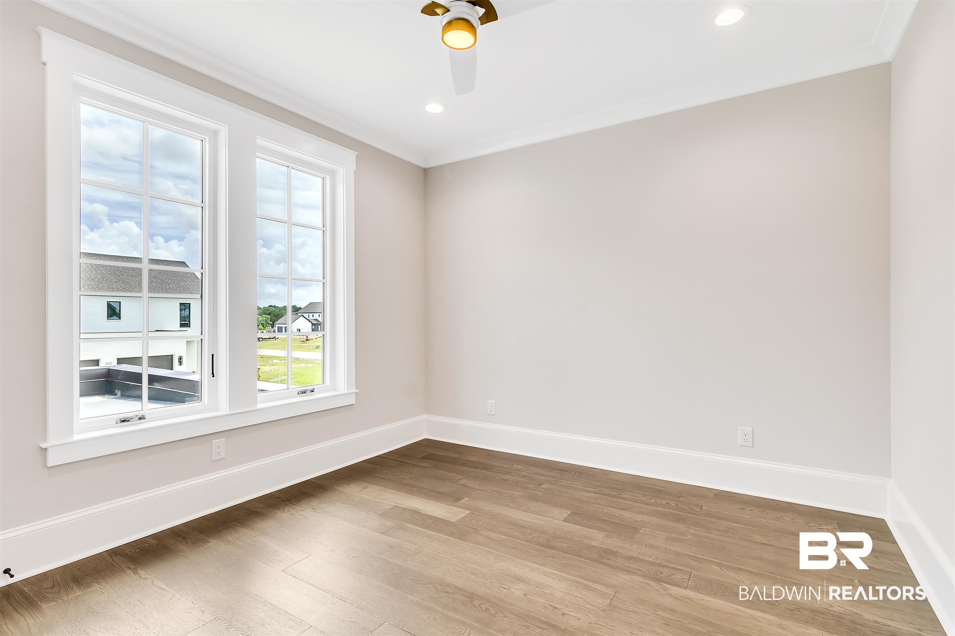 829 Inlet Circle Gulf Shores, AL 36542 - Photo 13 of 31 Empty room with hardwood / wood-style floors, ceiling fan, and crown molding
