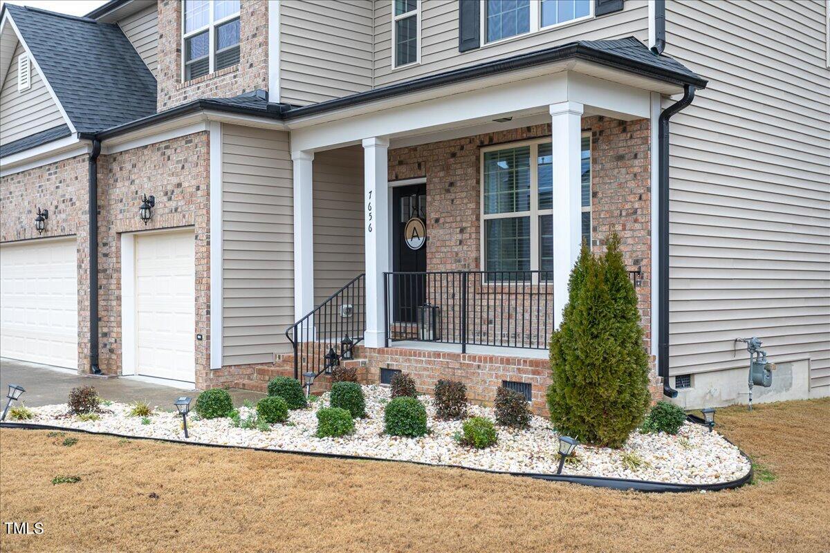 7656 Channery Way Raleigh, NC 27616 - Photo 6 of 44 Exterior Front with custom landscaping