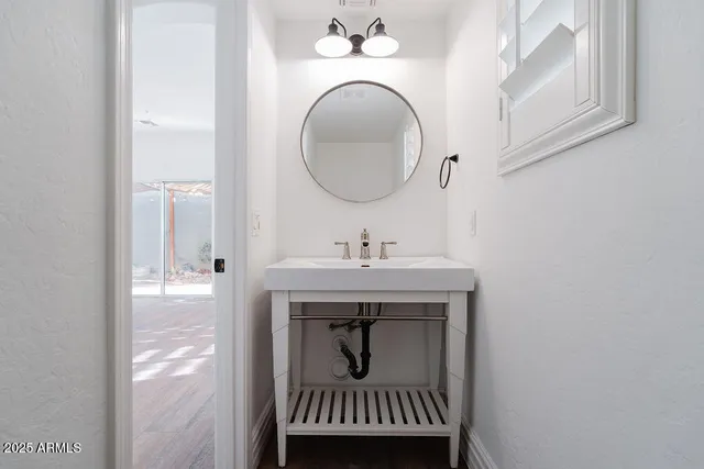 a bathroom with a sink and a mirror