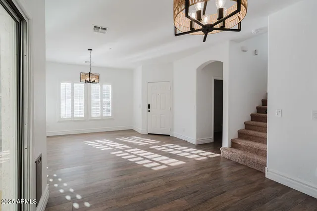 an empty room with windows and entryway