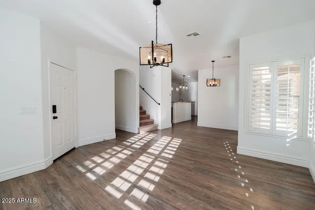 a view of a room with wooden floor closet and windows