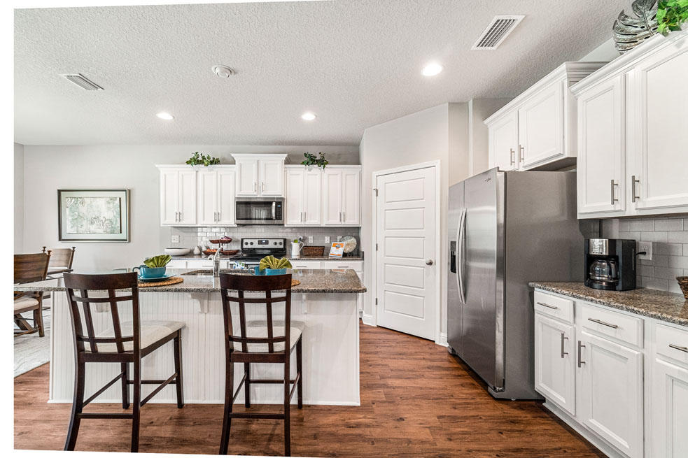 231 Conner Circle Santa Rosa Beach, FL 32459 - Photo 8 of 19 a kitchen with refrigerator cabinets dining table and chairs