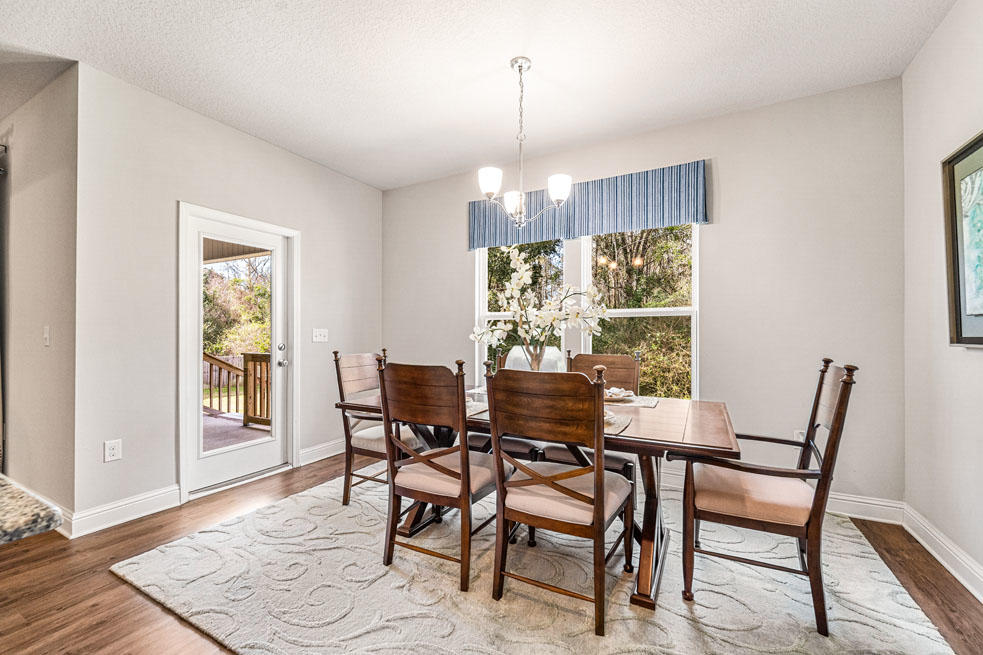 231 Conner Circle Santa Rosa Beach, FL 32459 - Photo 10 of 19 a view of a dining room with furniture window and wooden floor