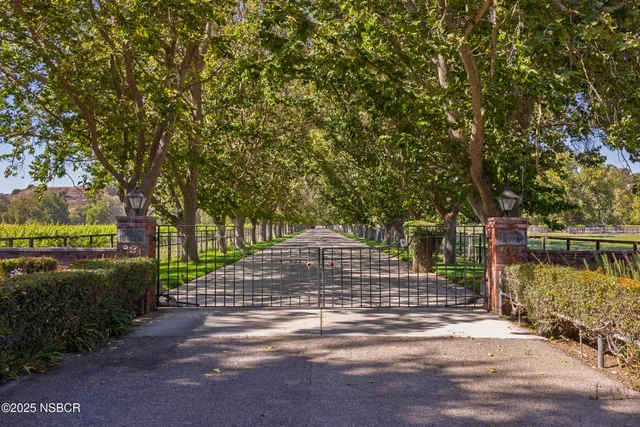 a view of a street with a house in the background