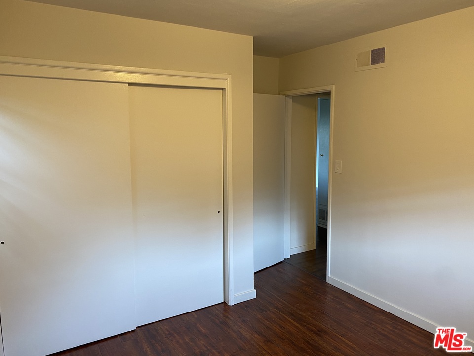 202 Spieth Way Riverside, CA 92507 - Photo 14 of 16 a view of an empty room with wooden floor