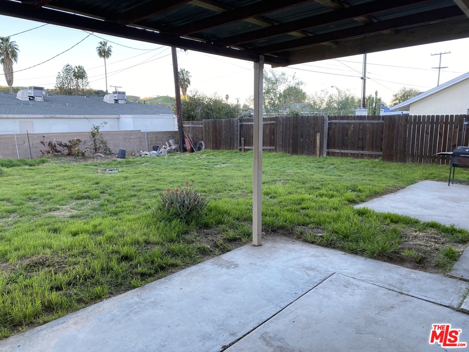 202 Spieth Way Riverside, CA 92507 - Photo 6 of 16 a view of a backyard with plants and wooden fence