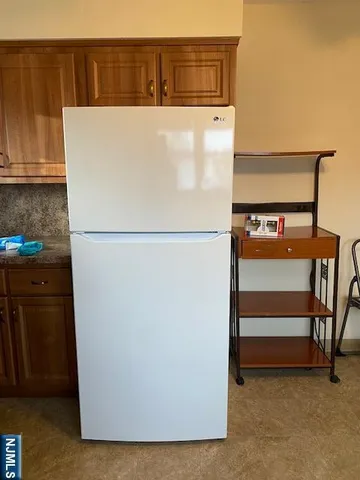 a white refrigerator freezer sitting in a kitchen