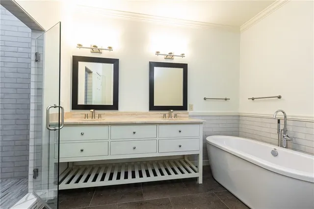 a bathroom with a sink mirror and a bathtub