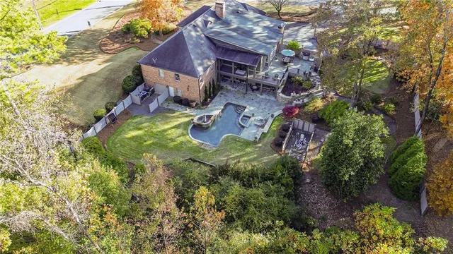 an aerial view of a house with swimming pool and garden