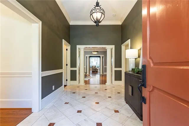 a view of a hallway with entryway dining table and chairs