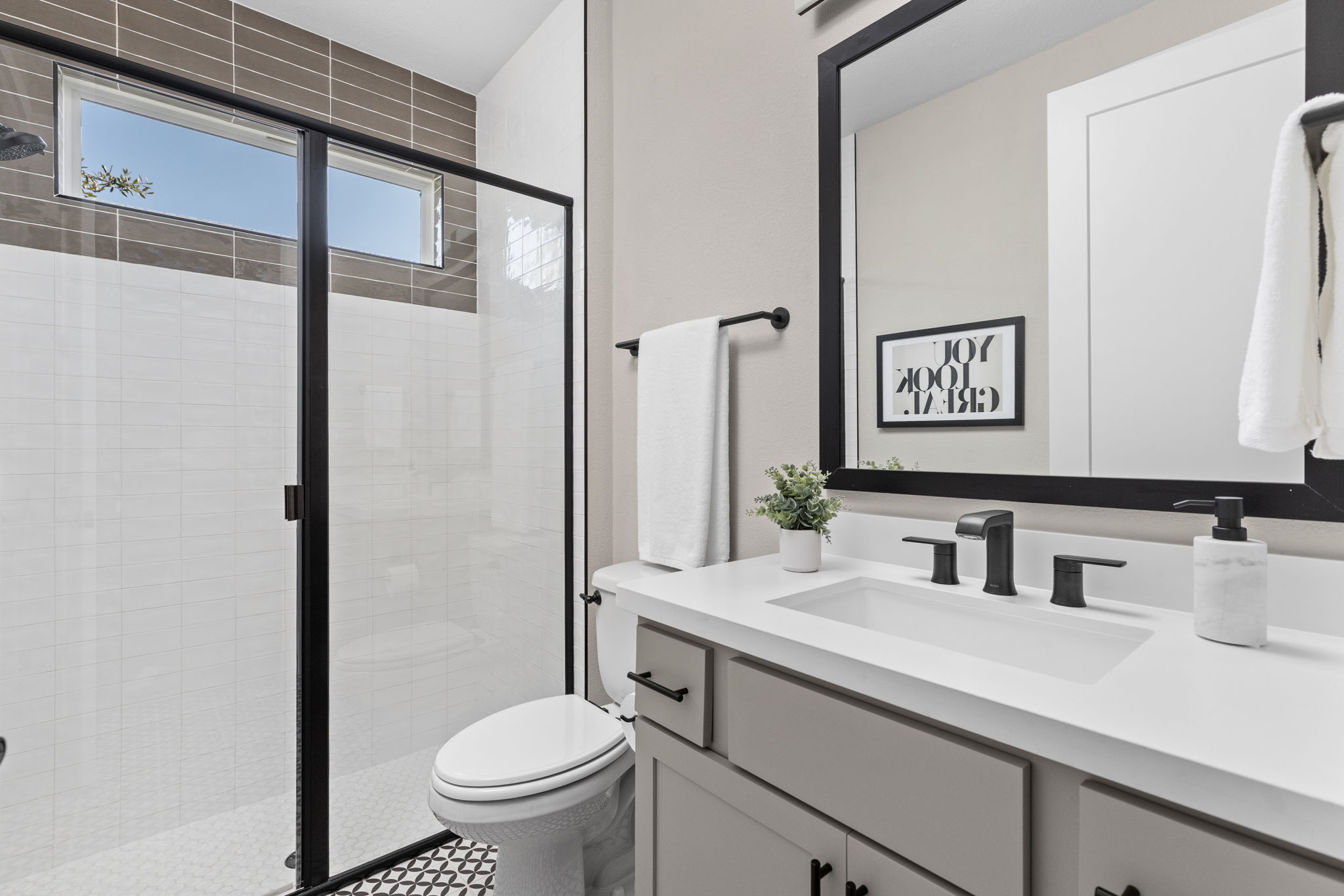 829 Pink Granite Boulevard Dripping Springs, TX 78620 - Photo 13 of 30 Beautifully appointed guest bathroom with clean, timeless finishes.