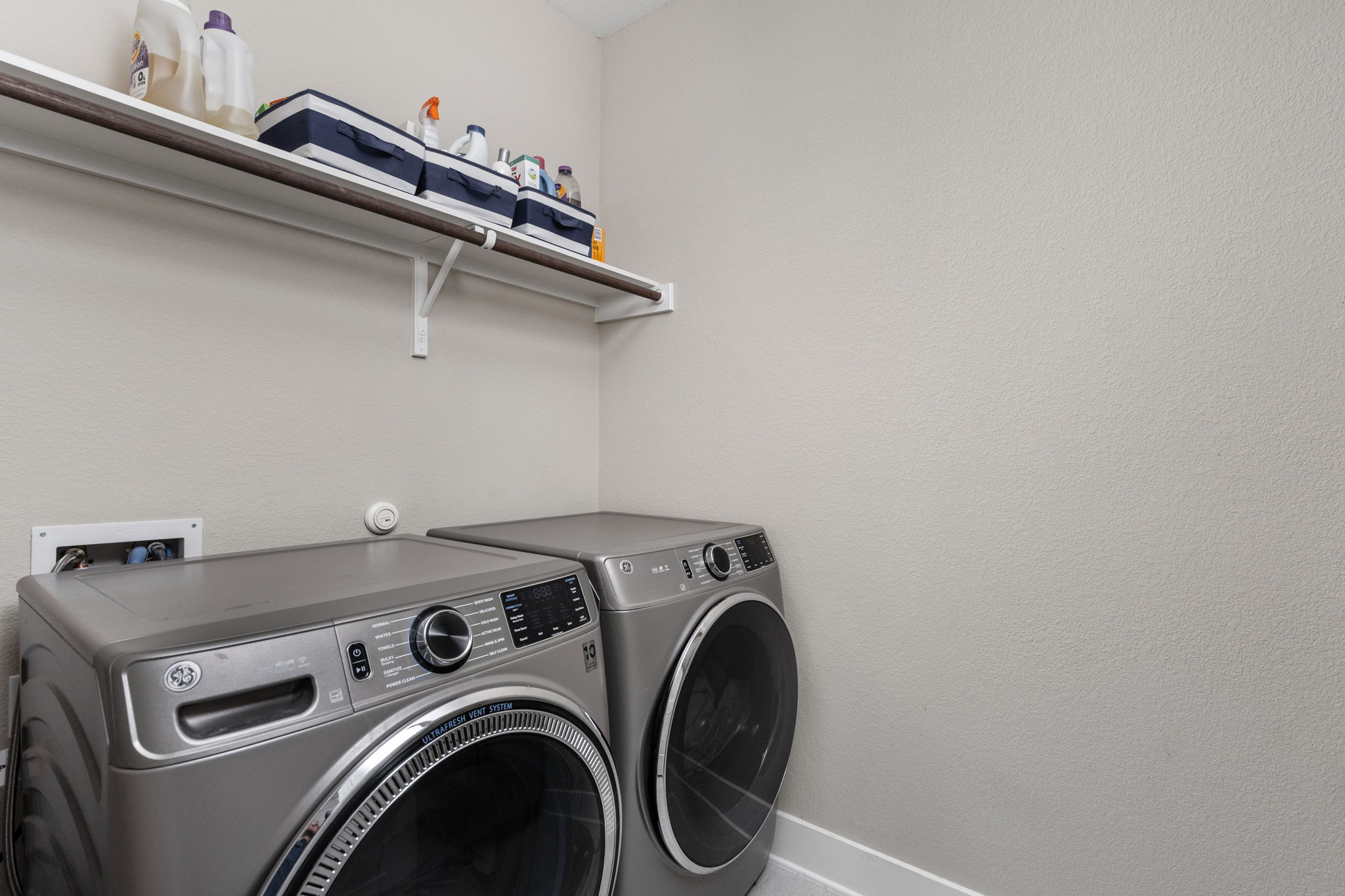 829 Pink Granite Boulevard Dripping Springs, TX 78620 - Photo 17 of 30 Spacious laundry room with built-in shelving for organized storage.