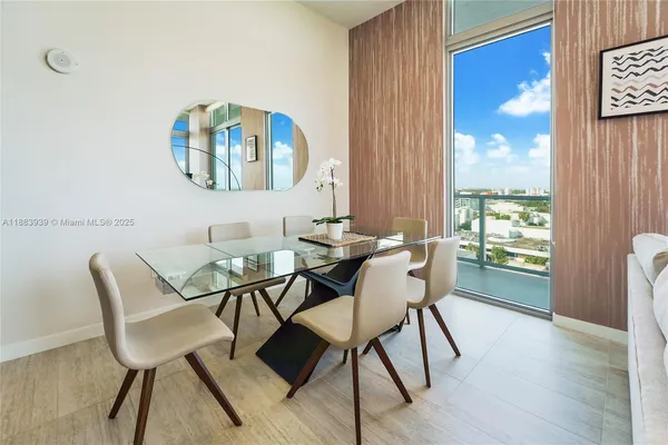 a dining room with furniture and wooden floor