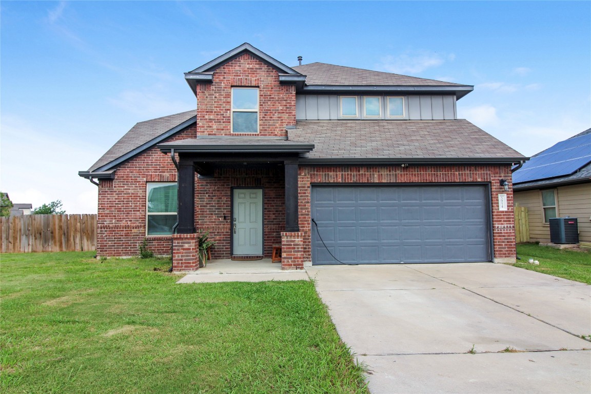 a front view of a house with a yard and garage