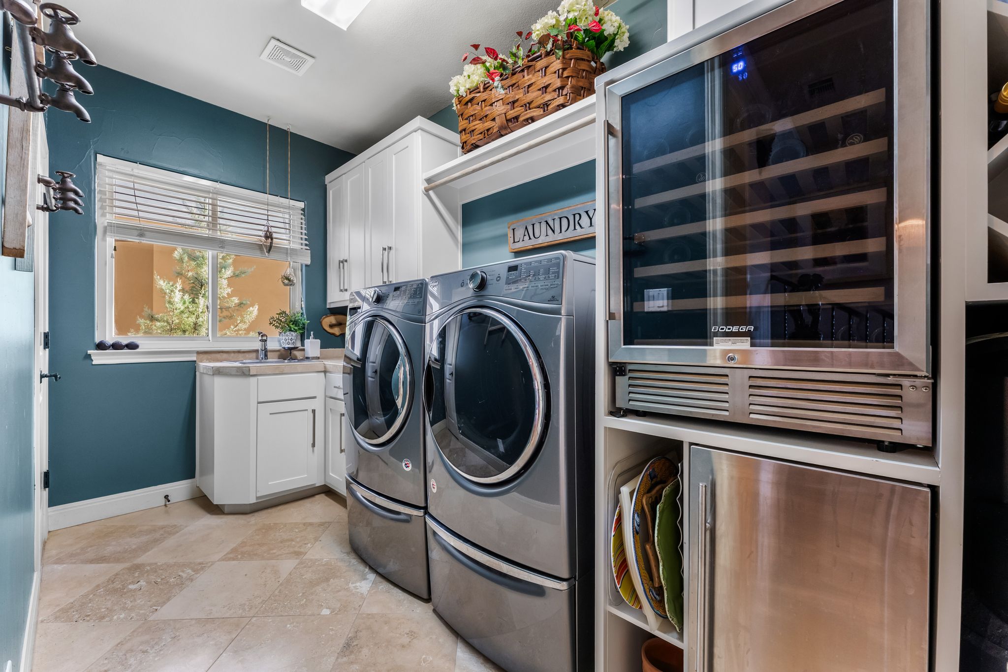 1901 Sea Eagle View Austin, TX 78738 - Photo 26 of 39 Laundry area featuring beverage cooler, ice maker, washer and dryer, and cabinet space