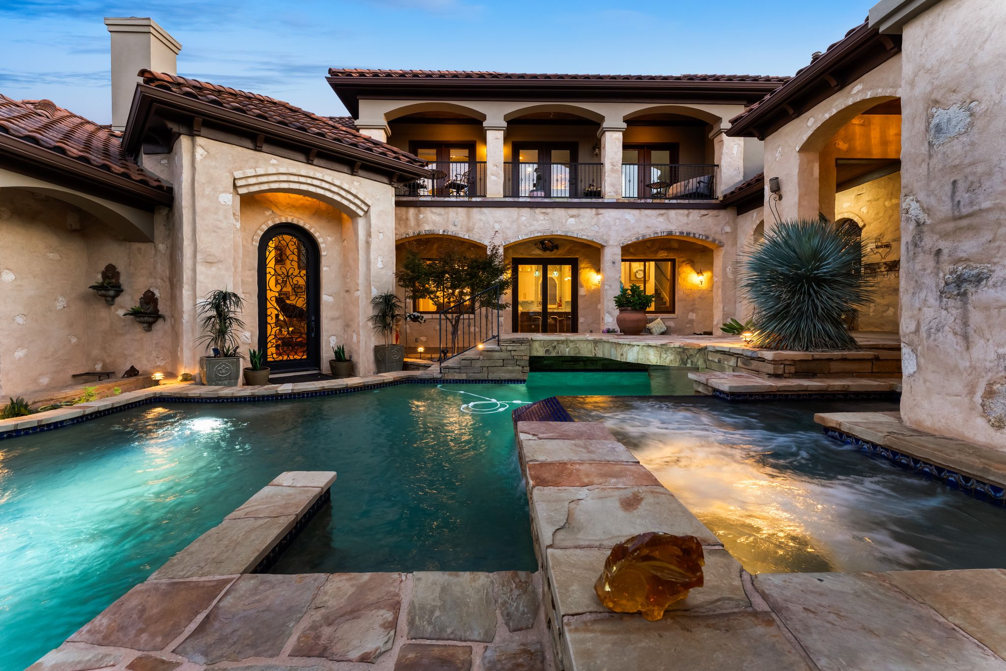 1901 Sea Eagle View Austin, TX 78738 - Photo 8 of 39 Back of house with resort style pool and hot tub at dusk