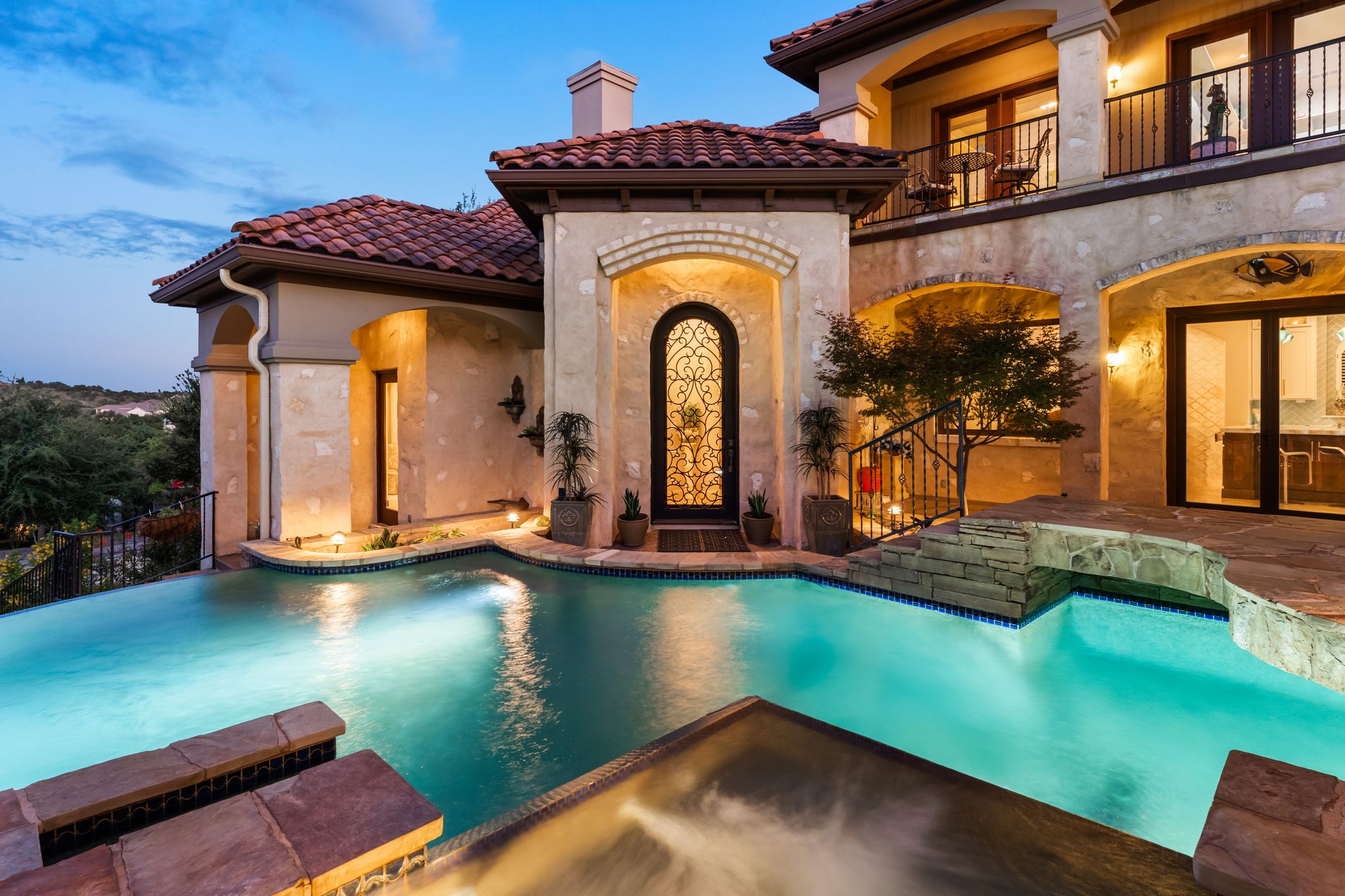 1901 Sea Eagle View Austin, TX 78738 - Photo 9 of 39 Back of house with resort style pool and hot tub at dusk